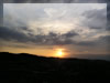 高尾山へ沈む夕陽の写真素材